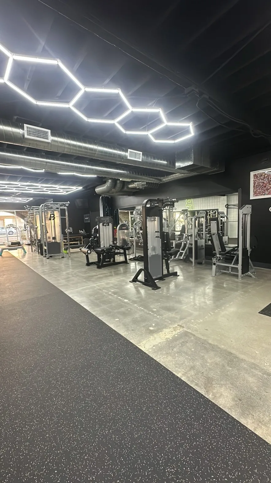 Strength machine floor beneath hexagonal ceiling lights