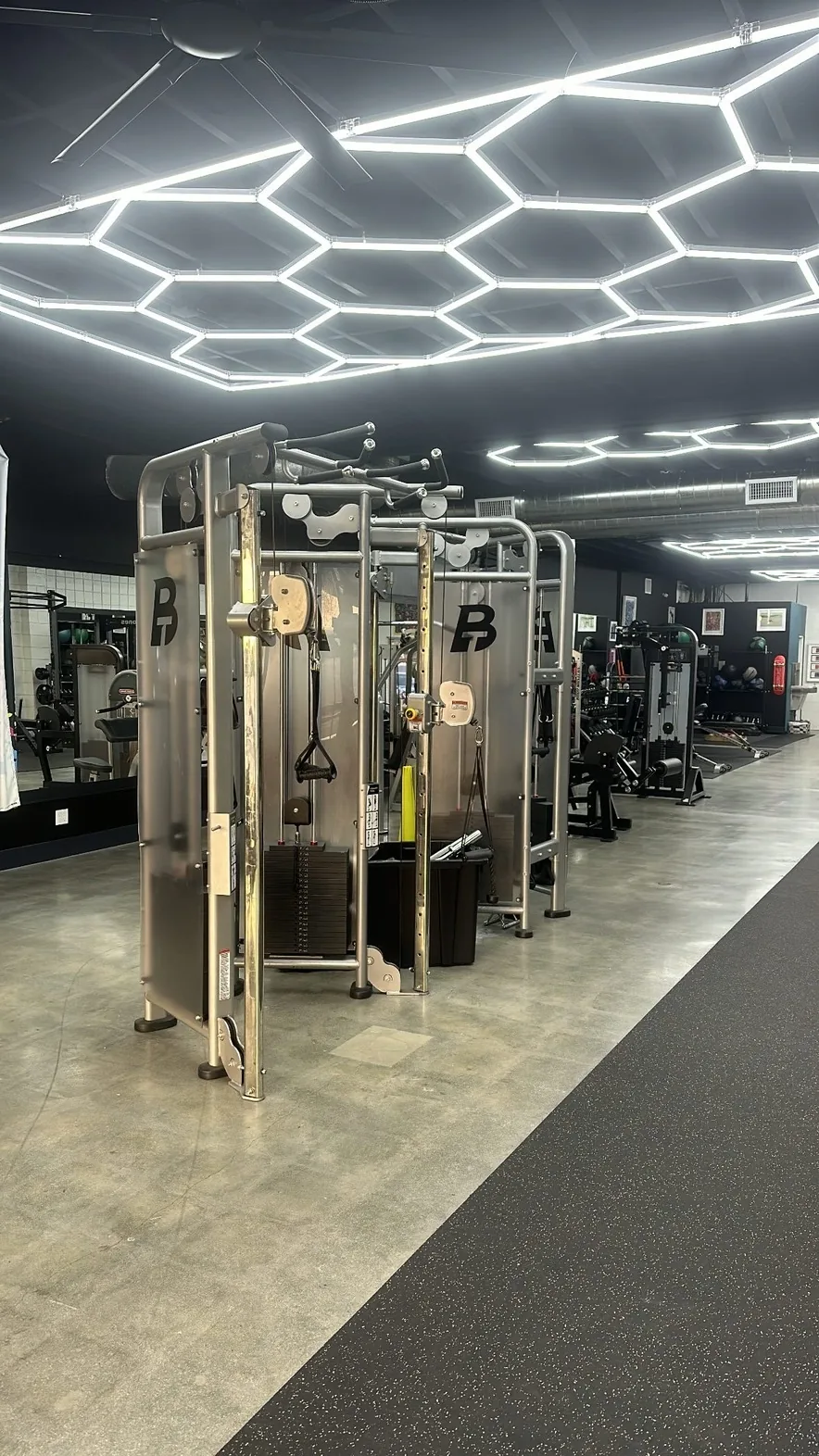 Branded functional trainers under hexagonal ceiling lights