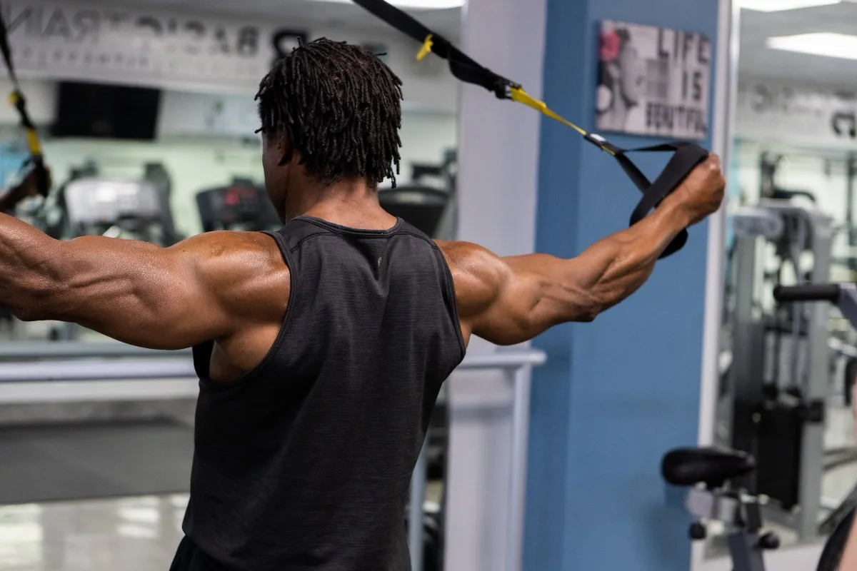 Athlete performing suspension trainer flys at BASIC Training private fitness center